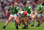 30 May 1999; Stephen Frampton of Waterford in action against Mark Foley, left, and James Moran of Limerick during the Guinness Munster Senior Hurling Championship quarter-final match between Limerick and Waterford at Páirc Uí Chaoimh in Cork. Photo by Ray McManus/Sportsfile