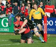 18 February 2006; Anthony Foley, Munster, goes over for a try despite the attention of Jon Petrie, Glasgow Warriors. Celtic League 2005-2006, Munster v Glasgow Warriors, Thomond Park, Limerick. Picture credit: Kieran Clancy / SPORTSFILE
