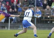 19 February 2006; Paul Flynn, Waterford, scores the only goal of the game despite the effort of Malachy Travers, Wexford. Allianz National Hurling League, Division 1A, Round 1, Waterford v Wexford, Dungarvan, Co. Waterford. Picture credit: Matt Browne / SPORTSFILE
