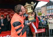 1 May 2014; Jockey Davy Russell celebrates with the cup after winning the Ladbrokes World Series Hurdle aboard Jetson. Punchestown Racecourse, Punchestown, Co. Kildare. Picture credit: Matt Browne / SPORTSFILE