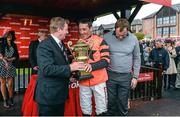 1 May 2014; Jockey Davy Russell is presented with the cup by An Taoiseach Enda Kenny, T.D., left, and former Republic of Ireland international Tony Cascarino after winning the Ladbrokes World Series Hurdle aboard Jetson. Punchestown Racecourse, Punchestown, Co. Kildare. Picture credit: Matt Browne / SPORTSFILE