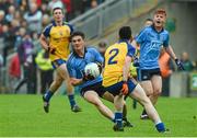 3 May 2014; Eric Lowndes, Dublin, is encouraged by team-mate Conor McHugh as he attempts to go past Cathal Kenny, Roscommon. Cadbury GAA Football All-Ireland U21 Championship Final, Dublin v Roscommon, O'Connor Park, Tullamore, Co. Offaly. Picture credit: Ray McManus / SPORTSFILE