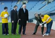 20 February 2006; Anne Marie McCoy, from the Arch Club, Portmarnock, Co. Dublin, gets some hurling tips from former Wexford Hurling manager and Chairman of the Social and Recreational Games Committee, Tony Dempsey, TD, watched by Gary O'Brien, also from the Arch Club, Portmarnock, Sean Kelly, President of the GAA, and An Taoiseach, Bertie Ahern TD, at the launch of the GAA's &quot;Gaelic Games for All&quot; initiative. Croke Park, Dublin.  Picture credit: Brendan Moran / SPORTSFILE