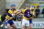 26 February 2006; Michael Jordan, Wexford, is tackled by Tommy Holland, left, and Conor Harrison, Clare. Allianz National Hurling League, Division 1A, Round 2, Wexford v Clare, Wexford Park, Wexford. Picture credit: Matt Browne / SPORTSFILE