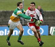 12 March 2006; Ryan McMenamin, Tyrone, is tackled by Karl Slattery, Offaly. Allianz National Football League, Division 1A, Round 4, Offaly v Tyrone, O'Connor Park, Tullamore, Co. Offaly. Picture credit: Oliver McVeigh / SPORTSFILE