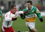 12 March 2006; Brian McGuigan, Tyrone, in action against Karl Slattery, Offaly. Allianz National Football League, Division 1A, Round 4, Offaly v Tyrone, O'Connor Park, Tullamore, Co. Offaly. Picture credit: Oliver McVeigh / SPORTSFILE
