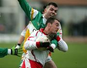 12 March 2006; Brian McGuigan, Tyrone, in action against Sean Casey, Offaly. Allianz National Football League, Division 1A, Round 4, Offaly v Tyrone, O'Connor Park, Tullamore, Co. Offaly. Picture credit: Oliver McVeigh / SPORTSFILE