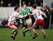 12 March 2006; Karl Slattery, Offaly, in action against Ciaran Gourley and Conor Gormley, Tyrone. Allianz National Football League, Division 1A, Round 4, Offaly v Tyrone, O'Connor Park, Tullamore, Co. Offaly. Picture credit: Oliver McVeigh / SPORTSFILE