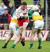12 March 2006; Stephen O'Neill, Tyrone, is tackled by Sean Casey and Niall Grennan, Offaly. Allianz National Football League, Division 1A, Round 4, Offaly v Tyrone, O'Connor Park, Tullamore, Co. Offaly. Picture credit: Oliver McVeigh / SPORTSFILE