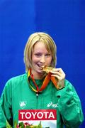 10 March 2006; Ireland's Derval O'Rourke with her gold medal after victory in the 60m hurdles at the World Indoor Championships, Moscow. Picture credit: Mark Shearman / SPORTSFILE