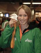 13 March 2006; Derval O'Rourke, who won a gold medal in the 60m Hurdles at the World Indoor Athletics Championships in Moscow on her arrival home at Dublin Airport, Dublin. Picture credit: Ray McManus / SPORTSFILE
