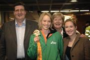 13 March 2006; Derval O'Rourke, who won a gold medal in the 60m Hurdles at the World Indoor Athletics Championships in Moscow, her parents Eva and Terry and her sister Clodagh on her arrival home at Dublin Airport, Dublin. Picture credit: Ray McManus / SPORTSFILE