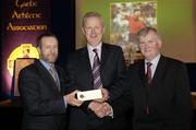 10 March 2006; Pat Ahern is presented with his award by GAA President Sean Kelly and Frank Burke, Chairman of the National Referees’ Committee, right, at the National Referees' Awards Banquet. Croke Park, Dublin. Picture credit: Ray McManus / SPORTSFILE