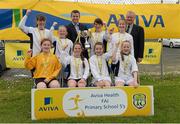 13 May 2014; Girls from Scoil Cholmcille, Greencastle, Innisowen, Co. Donegal, with Damien Flaherty, Aviva, centre, and Alex Harkin, FAI Schools, celebrate with the cup after winning the Girl's section B. Aviva Health FAI Primary School 5’s Ulster Finals, Ballyare, Donegal League HQ, Letterkenny, Co. Donegal. Picture credit: Oliver McVeigh / SPORTSFILE