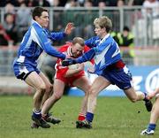19 March 2006; Gerard Cavlan, Tyrone, is tackled by Kieran McManus, right, and Colm Flanagan, Monaghan. Allianz National Football League, Division 1A, Round 5, Tyrone v Monaghan, Healy Park, Omagh, Co. Tyrone. Picture credit: Oliver McVeigh / SPORTSFILE