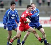 19 March 2006; Mickey Mc Gee, Tyrone, is tackled by Keith Sherrin, right, and Paul McGuigan, Monaghan. Allianz National Football League, Division 1A, Round 5, Tyrone v Monaghan, Healy Park, Omagh, Co. Tyrone. Picture credit: Oliver McVeigh / SPORTSFILE
