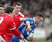 19 March 2006; Stephen Gollogly, Monaghan, is tackled by Dermot Carlin, left, and Colin Holmes, Tyrone. Allianz National Football League, Division 1A, Round 5, Tyrone v Monaghan, Healy Park, Omagh, Co. Tyrone. Picture credit: Oliver McVeigh / SPORTSFILE