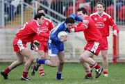 19 March 2006; Fergal Duffy, Monaghan, is tackled by Davy Harte, left, Conor Gormley, Tyrone. Allianz National Football League, Division 1A, Round 5, Tyrone v Monaghan, Healy Park, Omagh, Co. Tyrone. Picture credit: Oliver McVeigh / SPORTSFILE