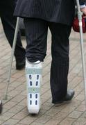 19 March 2006; Ireland's Denis Leamy with his leg in a brace on the team's homecoming at Dublin Airport, Dublin. Picture credit: Brendan Moran / SPORTSFILE