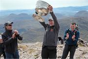 16 May 2014; Legendary GAA Commentator Mícheál Ó Muircheartaigh lifts the Sam Maguire Cup on the Summit of Carrauntoohil, MacGillycuddy's Reeks, Co. Kerry, with programme director and former Galway star Alan Kerins, left, and Tom Prendergast, 1969 Kerry All- Ireland winner, during the 'Sam to Summit' in aid of the Alan Kerins Project which saw Sam Maguire and representatives and players with All-Ireland football medals from each of the 32 counties reach the top of Ireland’s highest mountain. Carrauntoohil, Co. Kerry. Picture credit: Valerie O'Sullivan / SPORTSFILE