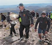 16 May 2014; Legendary GAA Commentator Mícheál Ó Muircheartaigh lifts the Sam Maguire Cup on the Summit of Carrauntoohil, MacGillycuddy's Reeks, Co. Kerry, with programme director and former Galway star Alan Kerins, right, during the 'Sam to Summit' in aid of the Alan Kerins Project which saw Sam Maguire and representatives and players with All-Ireland football medals from each of the 32 counties reach the top of Ireland’s highest mountain. Carrauntoohil, Co. Kerry. Picture credit: Valerie O'Sullivan / SPORTSFILE