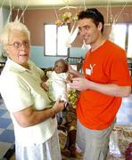 28 March 2006; Galway hurler, Alan Kerins, with Presentation Sister, Mary Vianney and baby John at the the Cheshire Home for Vulnerable and Orphaned Children which is run by the Presentation Sisters in Kaoma, Zambia. Picture credit: Damien Eagers / SPORTSFILE