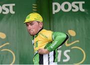 18 May 2014; Stage winner Robert McCarthy, An Post Chain Reaction, pulls on the yellow jersey after winning the opening stage of the 2014 An Post Rás. Dunboyne - Roscommon. Picture credit: Ramsey Cardy / SPORTSFILE