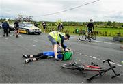 18 May 2014; Anthony Walsh, Central UCD Arrow, is treated for an injury after a crash during Stage 1 of the 2014 An Post Rás. Dunboyne - Roscommon. Picture credit: Ramsey Cardy / SPORTSFILE