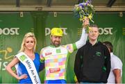 18 May 2014; Fraser Duncan, Meath, is presented with the King of the Mountains jersey by Miss An Post Rás Ruth McCourt, left, and John Gallen, The Bike Shop, after Stage 1 of the 2014 An Post Rás. Dunboyne - Roscommon. Picture credit: Ramsey Cardy / SPORTSFILE