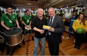 20 May 2014; St. Michael's AFC supporter Tommy Cunningham is presented with VIP match tickets by former Republic of Ireland international Ray Houghton during the FAI Junior Cup Aviva Communities Day ahead of Sunday's Final at the Aviva Stadium. Lowry's Bar, Main Street, Tipperary Town. Picture credit: Diarmuid Greene / SPORTSFILE
