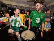 20 May 2014; St. Michael's AFC supporters Shane O'Grady, aged 8, is offered the chance to play the drums with drummer Colm Farrell, from Laois, during the FAI Junior Cup Aviva Communities Day ahead of Sunday's Final at the Aviva Stadium. Lowry's Bar, Main Street, Tipperary Town. Picture credit: Diarmuid Greene / SPORTSFILE