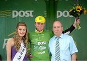 20 May 2014; Robert Jon McCarthy, An Post Chain Reaction, is presented with the An Post points leader jersey by Miss An Post Rás Charleville Laura Dundon, left, and Jimmy Hanrahan, Postmaster in Charleville, after Stage 3 of the 2014 An Post Rás. Lisdoonvarna - Charleville. Picture credit: Ramsey Cardy / SPORTSFILE