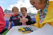 20 May 2014; Ballynanty Rovers AFC supporter Kieran Noonan, aged 3, along with Kathleen Lowe, takes a cupcake during the FAI Junior Cup Aviva Communities Day ahead of Sunday's Final at the Aviva Stadium. Ballynanty Community Centre, Limerick. Picture credit: Diarmuid Greene / SPORTSFILE