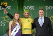 20 May 2014; Patrick Bevin, New Zealand National Team, is presented with the An Post yellow jersey by Miss An Post Rás Charleville Laura Dundon and Edward Geaney, Delivery Services Manager, An Post, after Stage 3 of the 2014 An Post Rás. Lisdoonvarna - Charleville. Picture credit: Ramsey Cardy / SPORTSFILE
