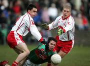 9 April 2006; James Gill, Mayo, is tackled by Ryan McMenamin and Kevin Hughes, Tyrone. Allianz National Football League, Division 1A, Round 7, Mayo v Tyrone, McHale Park, Castlebar, Co. Mayo. Picture credit: Oliver McVeigh / SPORTSFILE