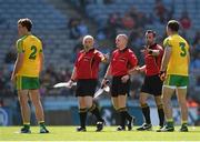 27 April 2014; Neil McGee, 3, Donegal, in conversation with, from left, linesmen Marty Duffy and Barry Cassidy, and referee David Gough, before being shown a yellow card. Allianz Football League Division 2 Final, Donegal v Monaghan, Croke Park, Dublin. Picture credit: Ray McManus / SPORTSFILE