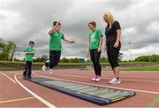22 May 2014; Eleven year old Robert McCarthy takes part in the standing long jump watched by Irish Long Jump record holder Kelly Proper, left, and Christine Whelan, Forest Feast Sales Manager Ireland, during the launch of the Forest Feast Athletics Summer Camp. Morton Stadium, Santry, Dublin. Picture credit: Matt Browne / SPORTSFILE