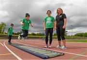 22 May 2014; Eleven year old Robert McCarthy takes part in the standing long jump watched by Irish Long Jump record holder Kelly Proper, left, and Christine Whelan, Forest Feast Sales Manager Ireland, during the launch of the Forest Feast Athletics Summer Camp. Morton Stadium, Santry, Dublin. Picture credit: Matt Browne / SPORTSFILE
