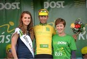 22 May 2014; Clemens Fankhauser, Tirol Cycling Team is presented with the An Post yellow jersey by Miss An Post Rás Clonakilty Emma O'Sullivan, left, and Gobnait O'Donovan, Working Leader, DSU, after Stage 5 of the 2014 An Post Rás. Cahirciveen - Clonakilty. Picture credit: Ramsey Cardy / SPORTSFILE