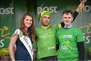 22 May 2014; Patrick Bevin, New Zealand National Team, is presented with the An Post points leader jersey by Miss An Post Rás Clonakilty Emma O'Sullivan and Kieran Murphy, Branch Manager, Clonakilty post office, after Stage 5 of the 2014 An Post Rás. Cahirciveen - Clonakilty. Picture credit: Ramsey Cardy / SPORTSFILE