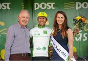 22 May 2014; Alex Peters, Madison Genesis, is presented with the Irish Sports Council Under 23 jersey by Miss An Post Rás Clonakilty Emma O'Sullivan, and Paudie Palmer, Board Member and Director, Cork Local Sports Partnership, after Stage 5 of the 2014 An Post Rás. Cahirciveen - Clonakilty. Picture credit: Ramsey Cardy / SPORTSFILE