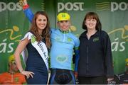 22 May 2014; Sean Lacey, Cork City Aquablue is presented with the One Direct County rider by Miss An Post Rás Clonakilty Emma O'Sullivan, left, and Tracy Ryan, Customer Service Advisor, One Direct, after Stage 5 of the 2014 An Post Rás. Cahirciveen - Clonakilty. Picture credit: Ramsey Cardy / SPORTSFILE