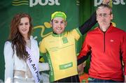 21 May 2014; Patrick Bevin, New Zealand National Team, is presented with the An Post yellow jersey by, Miss An Post Rás, Lauren O'Sullivan, left, and Eamonn Casey, Casey Cycles  after Stage 4 of the 2014 An Post Rás. Charleville - Cahirciveen. Picture credit: Ramsey Cardy / SPORTSFILE
