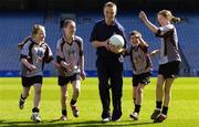 5 April 2006; Laois footballer Ross Munnelly is chased by pupils from Scoil Mobhi, from left, Fiona Tuite, Adam Ronayne, Iarla O'Donmhnaill, and Orla Keegan, at the launch of the Leinster Vhi Cúl Camps. Inter county stars from all over Leinster were present to announce details of the popular Summer Camps which start on July 3rd. The Vhi Cúl Camps are a nationally co-ordinated programme that aims to encourage children to learn and develop sporting and life-skills by particpating in Gaelic Games, in a fun, non-competitive environment. Croke Park, Dublin. Picture credit: Brian Lawless / SPORTSFILE