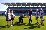 5 April 2006; Inter county footballers Paul Casey, Dublin, and Ross Munnelly, Laois, show young players from Na Fianna, from left, Fiona Tuite, Iarla O'Donmhnaill, Orla Keegan, and Adam Ronayne, a few skills at the launch of the Leinster Vhi Cúl Camps. Inter county stars from all over Leinster were present to announce details of the popular Summer Camps which start on July 3rd. The Vhi Cúl Camps are a nationally co-ordinated programme that aims to encourage children to learn and develop sporting and life-skills by particpating in Gaelic Games, in a fun, non-competitive environment. Croke Park, Dublin. Picture credit: Brian Lawless / SPORTSFILE
