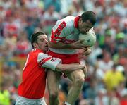 5 July 1999; Anthony Tohill of Derry in action against Paul McGrane of Armagh during the Ulster Senior Football Championship Semi-Final match between Armagh and Derry at St Tiernach's Park in Clones in Monaghan. Photo by David Maher/Sportsfile