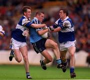 27 June 1999; Ciaran Whelan of Dublin is tackled by George Doyle, left, and Kevin Fitzpatrick of Laois during the Leinster Senior Football Championship Semi-Final match between Dublin and Laois at Croke Park in Dublin. Photo by Brendan Moran/Sportsfile