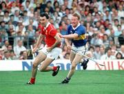16 July 1990; Ger Fitzgerald of Cork in action against Bobby Ryan of Tipperary during the Munster Senior Hurling Championship Final match between Tipperary and Cork at Semple Stadium in Thurles, Tipperary. Photo by Ray McManus/Sportsfile