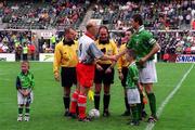 29 May 1999; Iain Dowie Northern Ireland and Niall Quinn of Republic of Ireland shake hands watched by Republic of Ireland mascot Christopher Gallagher, right, and Northern Ireland Mascot Anthony Brady, left, prior to the International Friendly match between Republic of Ireland and Northern Ireland at Lansdowne Road in Dublin. Photo by Ray McManus/Sportsfile