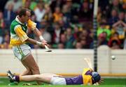 20 June 1999; Joe Dooley of Offaly shoots to score his side's first goal desite the tackle of Colm Kehoe of Wexford during the Guinness Leinster Senior Hurling Championship Semi-Final match between Offaly and Wexford at Croke Park in Dublin. Photo by Ray McManus/Sportsfile